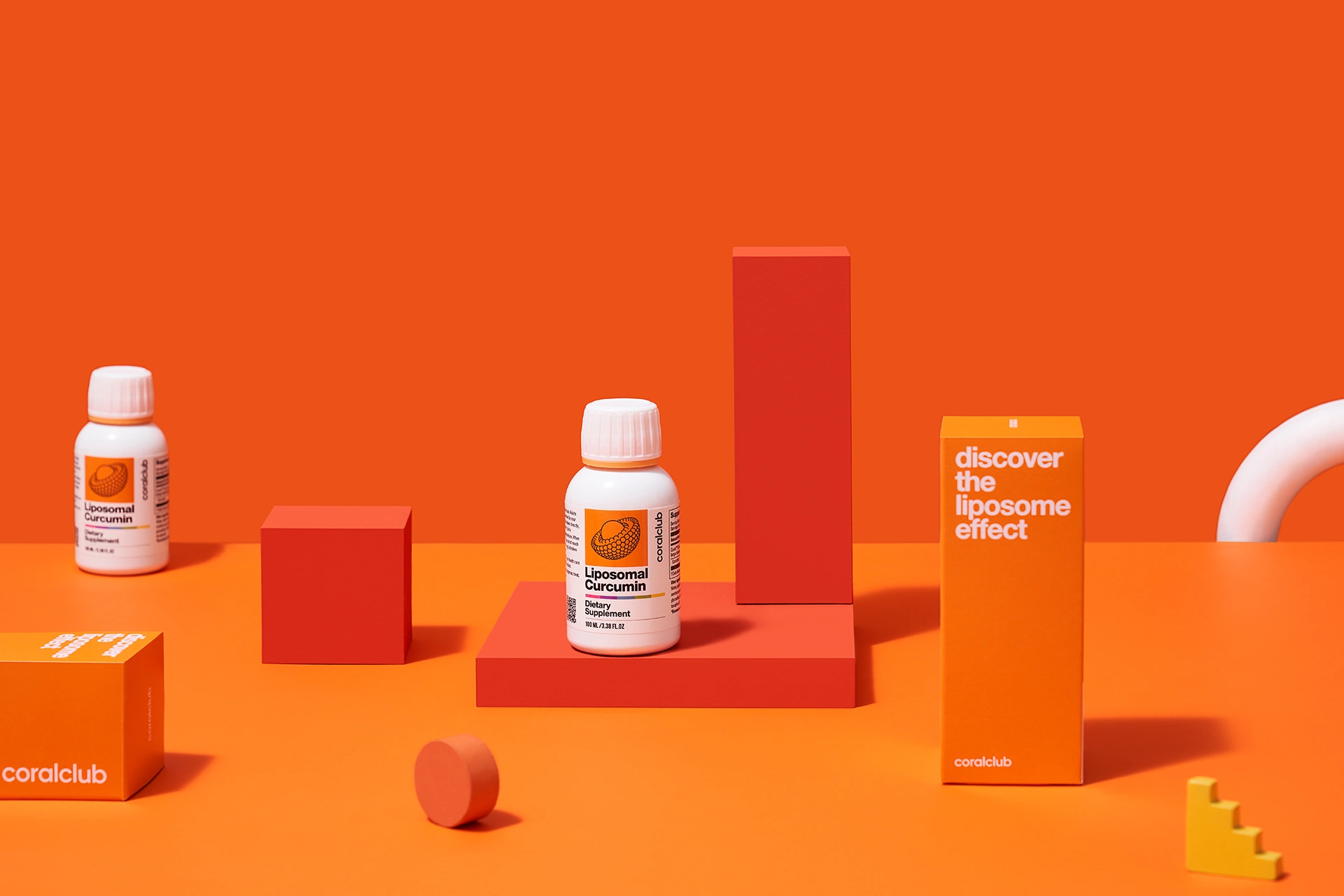 A bottle of Liposomal Curcumin against the background of fresh turmeric root
