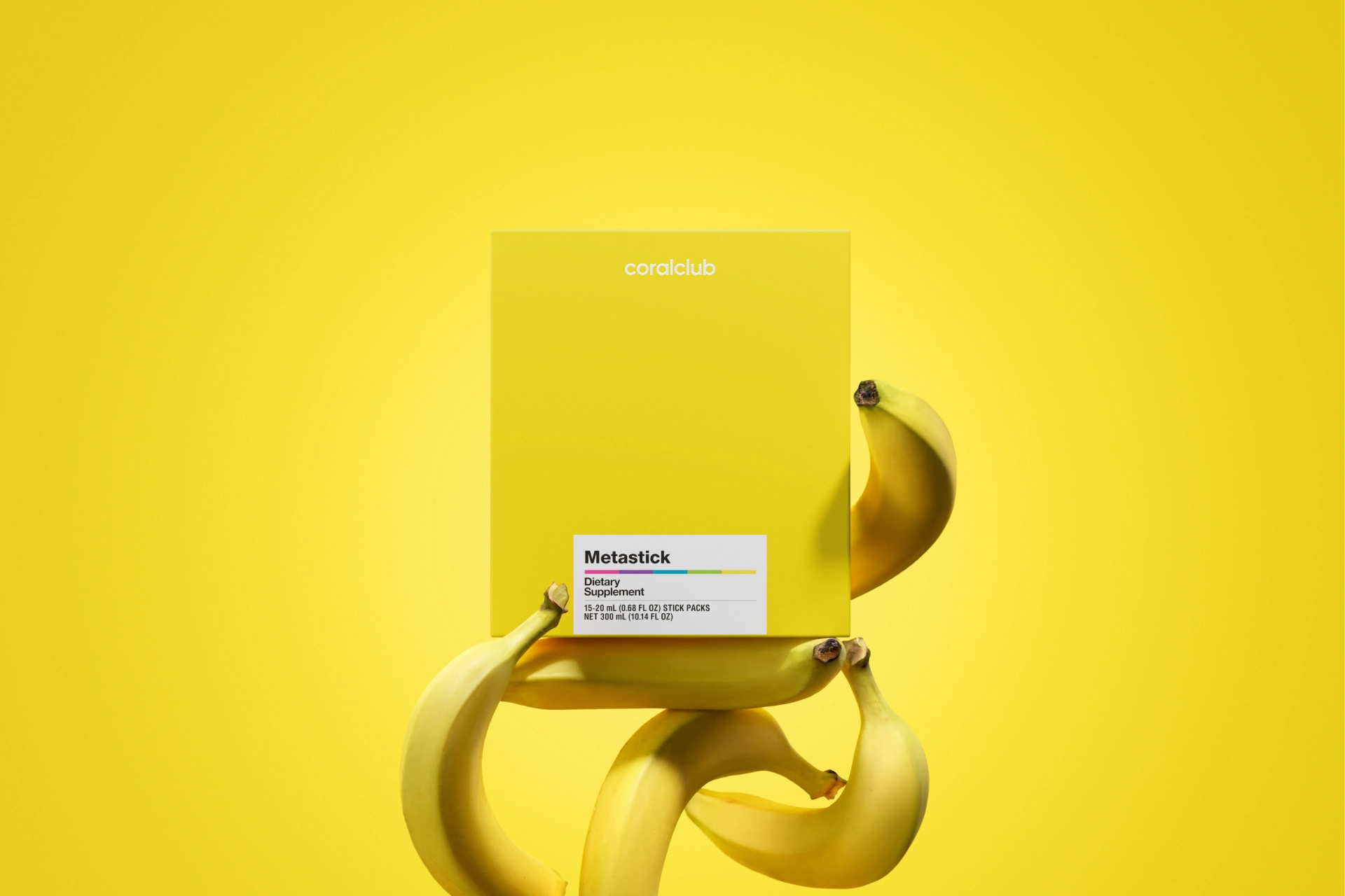 Metastick packaging in a lifestyle environment over fresh bananas, reflecting its natural composition