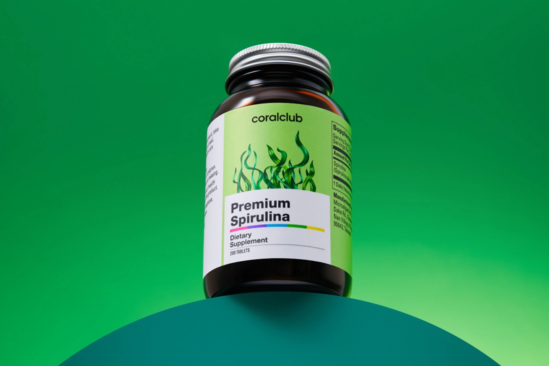Convenient tablet format of Premium Spirulina next to fresh green superfoods