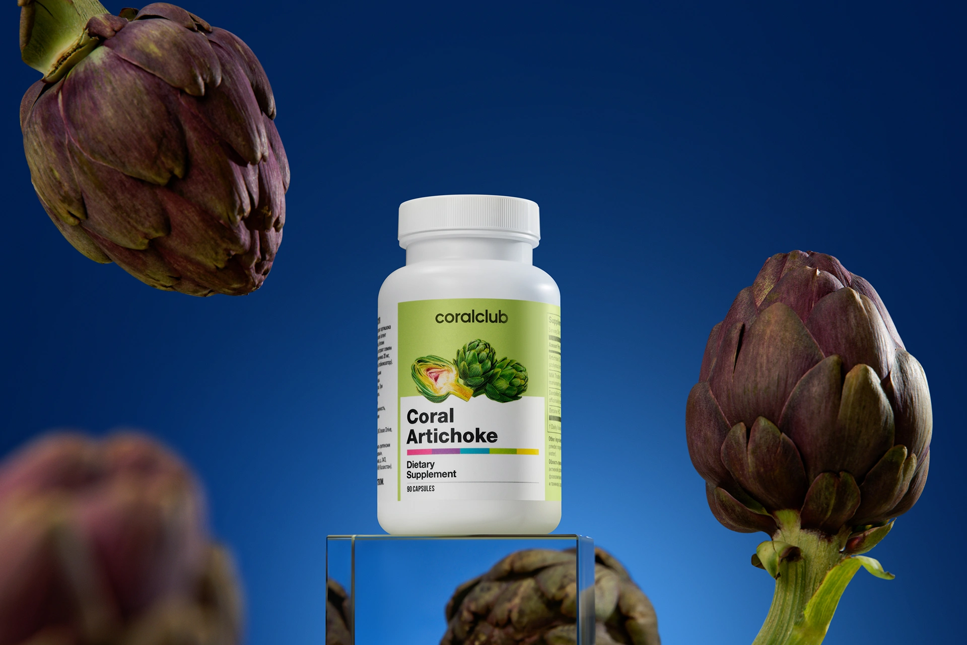 A bottle of Coral Artichoke complex surrounded by fresh botanical ingredients